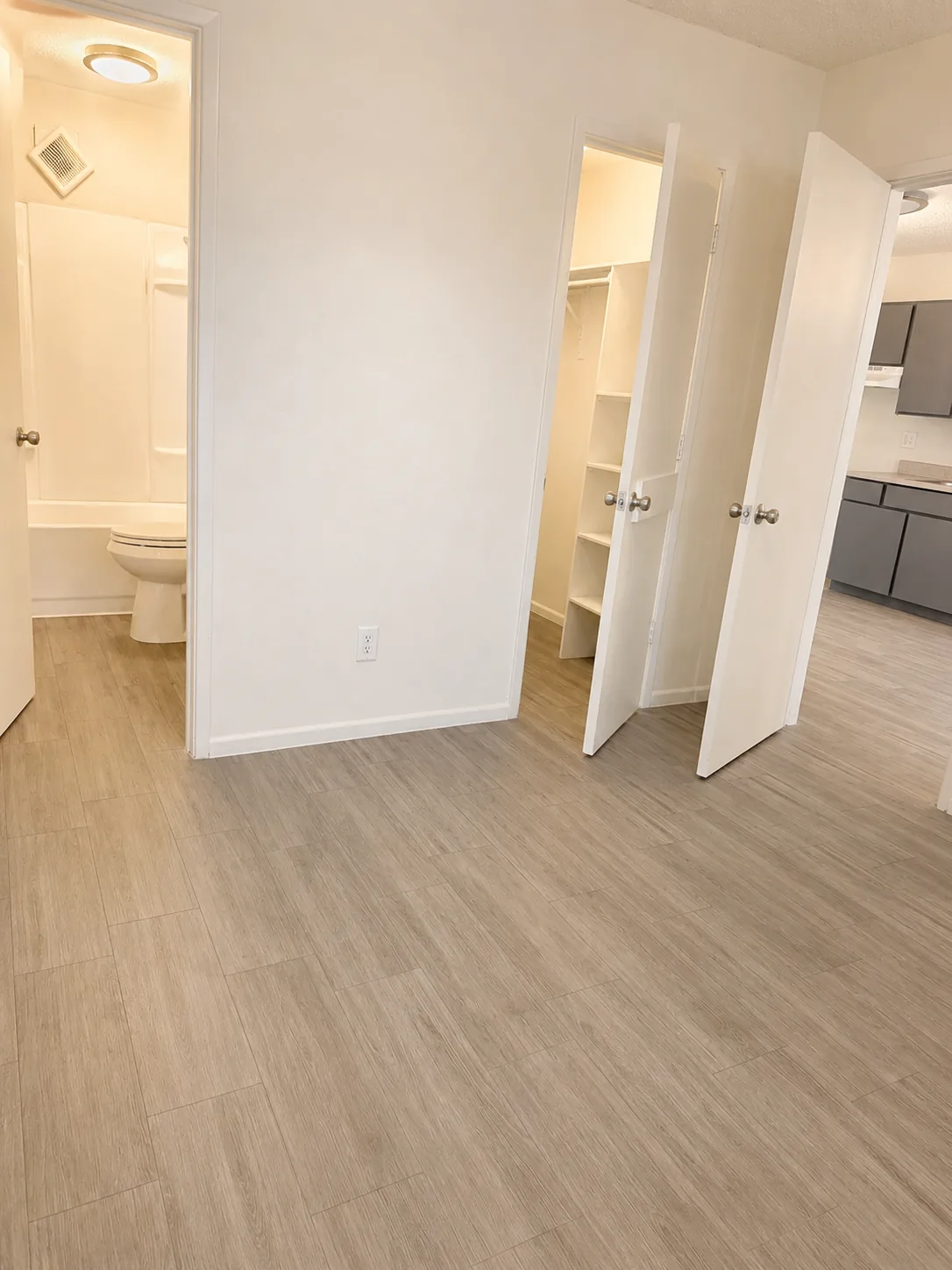 Living room and kitchen; furnishings and finishes vary by apartment